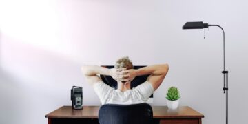 Person sitting at a desk holding their hip area