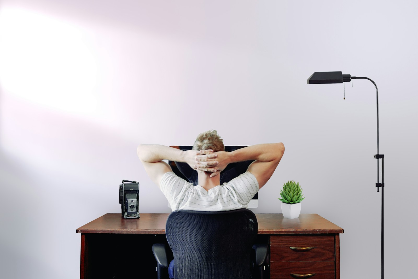 Person sitting at a desk holding their hip area