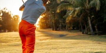 Golfer preparing to swing on a golf course